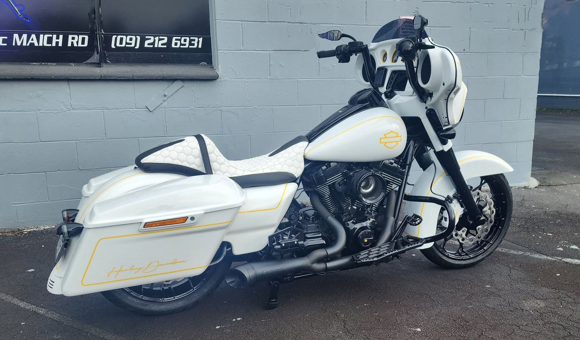 White bagger touring Harley at the workshop