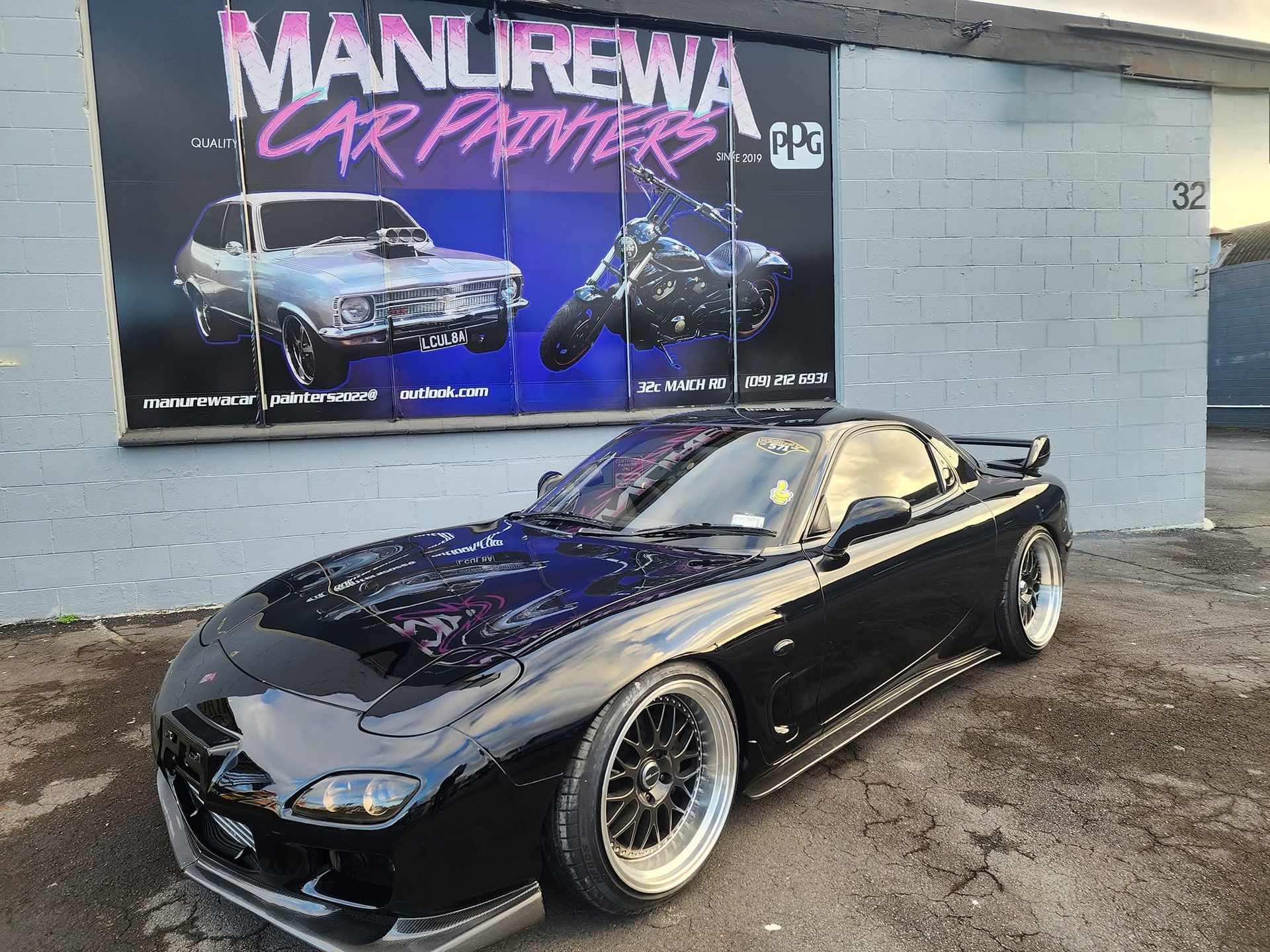Black Mazda RX-7 with a deep gloss finish